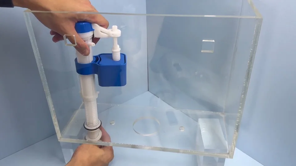Fill valve and float inside a clear demonstration toilet tank
