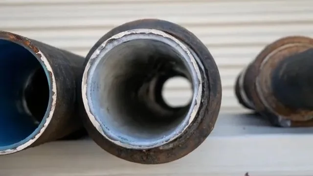Cut ends of steel pipe with an epoxy lining visible inside
