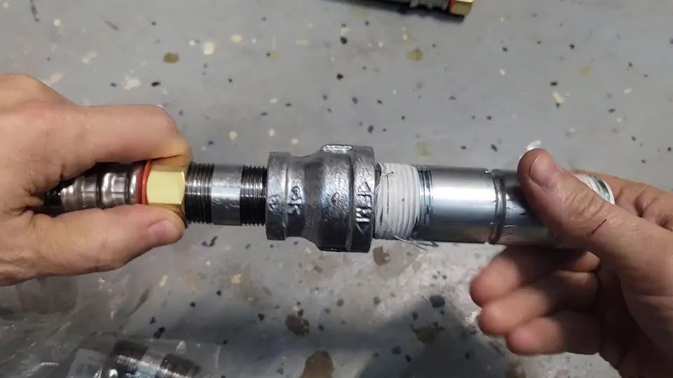 Hands joining threaded steel pipe fittings