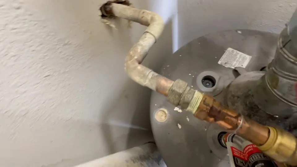 Copper connections and a shutoff valve on top of a tank water heater