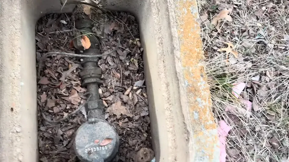 Water meter and shutoff valves inside an opened ground box